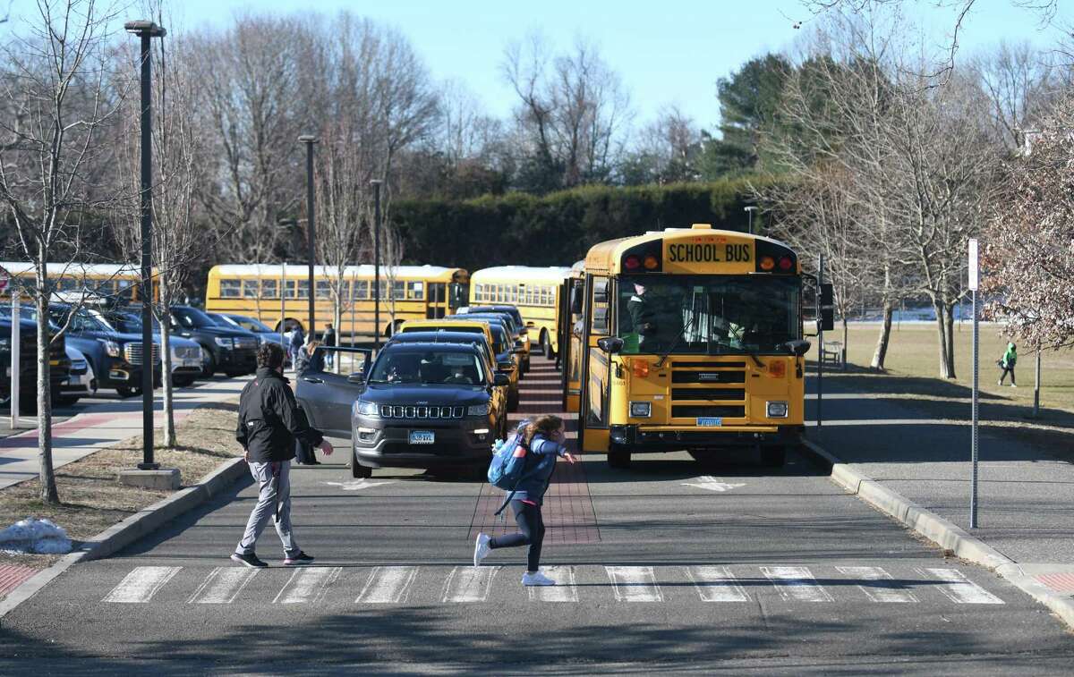 Students enter North Mianus School in the Riverside section of Greenwich, Conn. Tuesday, March 2, 2021.