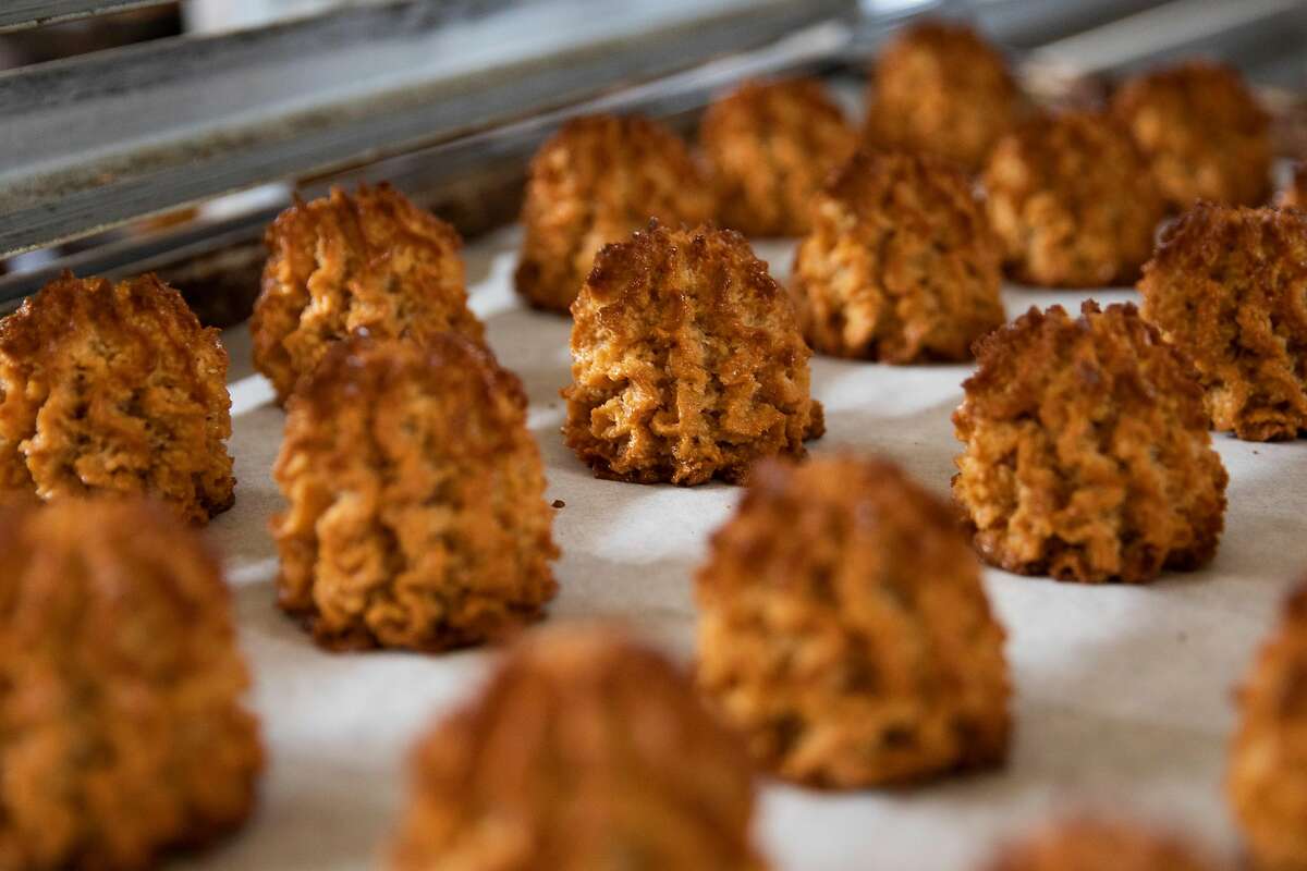 Freshly baked macaroons sit on a cooling tray in the kitchen of Grand Bakery in Oakland, Calif. Monday, March 15, 2021. The Passover recipe featured on Grand Bakery's famous macaroons takes 5 hours to make.The Passover recipe feature on Grand Bakery's famous macaroons takes 5 hours to make.