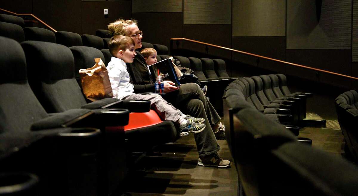 Leah Wiener, of Ridgefield, and her sons Max, 5, and Owen, 3, wait for a movie to start at the Prospector Theater. Friday, March 24, 2017, in Ridgefield, Conn.