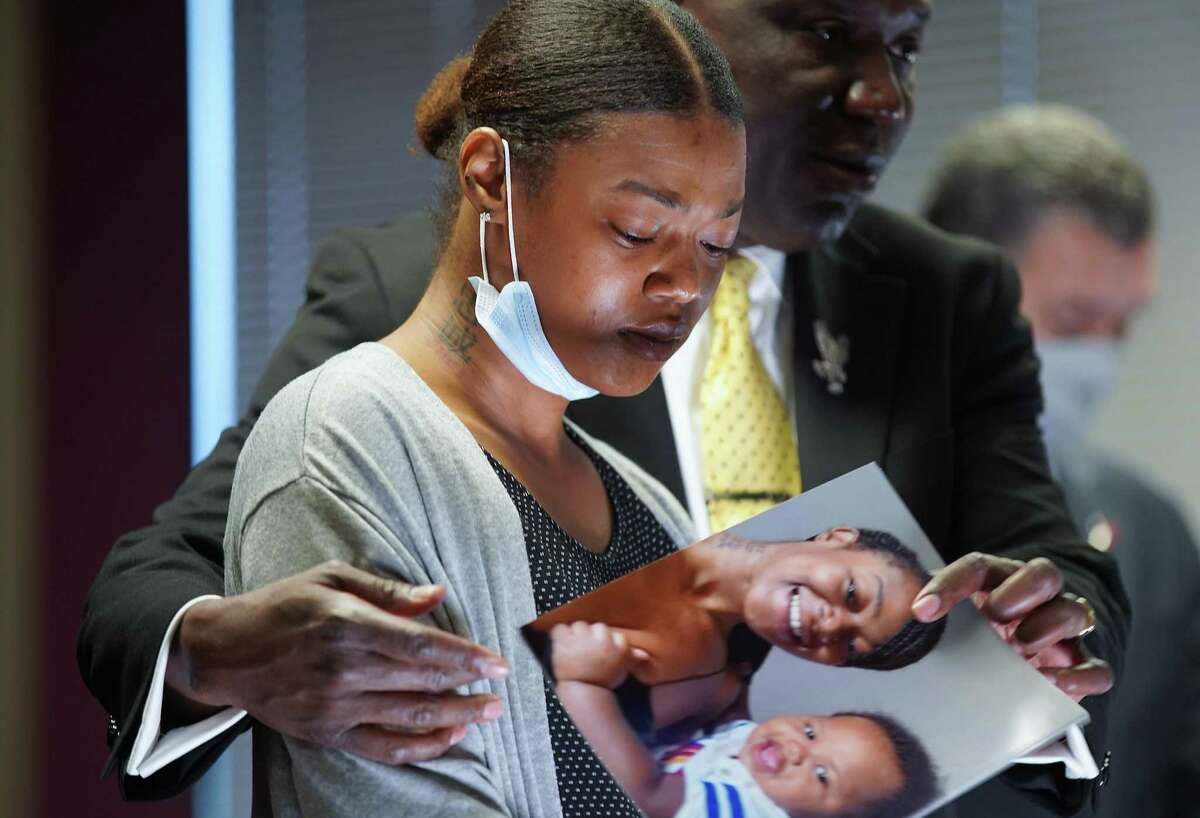 Daisha Smalls becomes emotional as attorney Ben Crump talks to the media about the condition of her on-year-old son, Legend, in Houston on Tuesday, March 16, 2021. Legend Smalls, 1, was hit in the head by a bullet by the Houston Police Department.