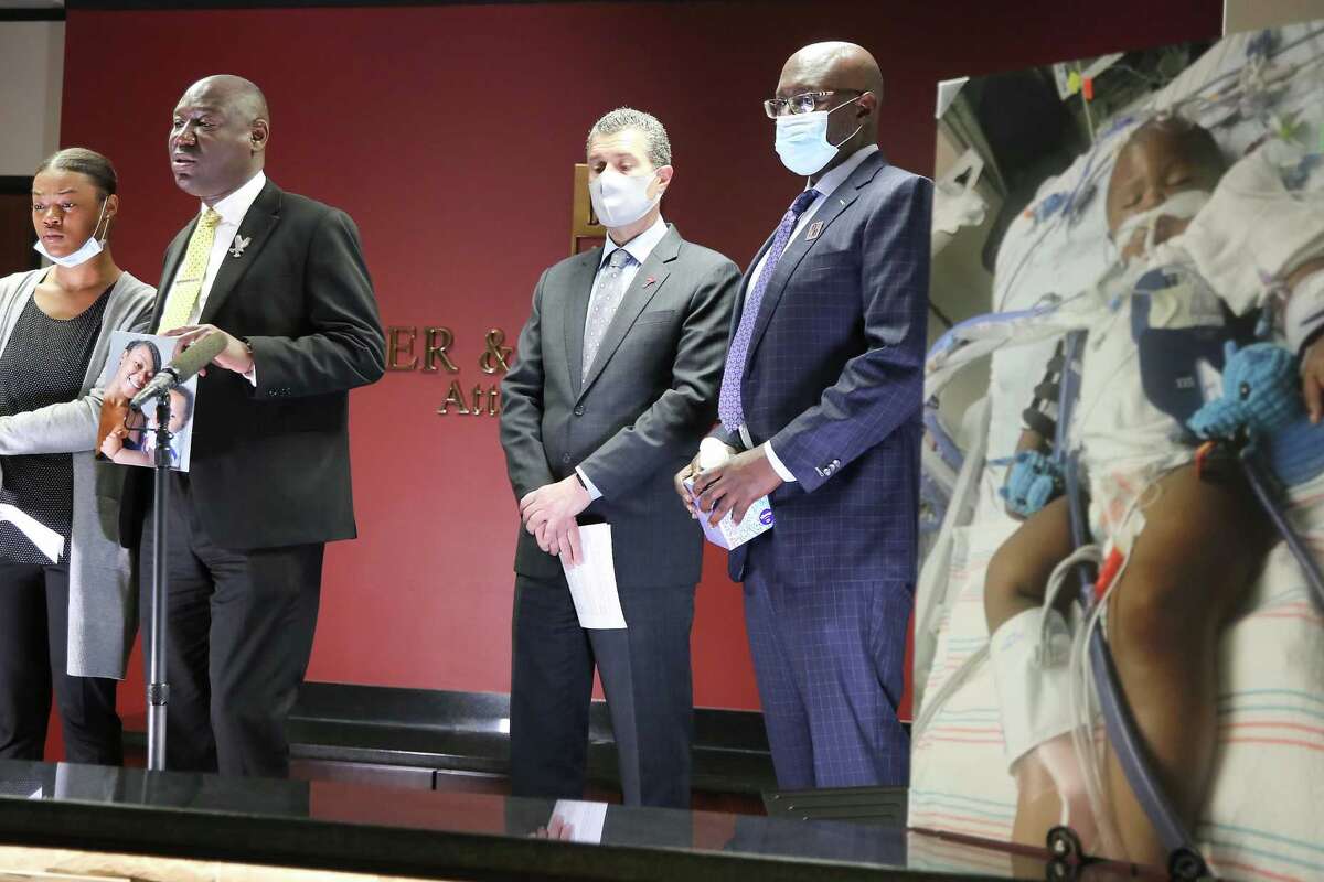 Attorney Ben Crump address the media with Daisha Smalls, from left, Antonio Romanucci and Darren Miller in Houston on Tuesday, March 16, 2021. Daisha's one-year-old son, Legend, was hit in the head by a bullet shot by Houston Police on March 3.