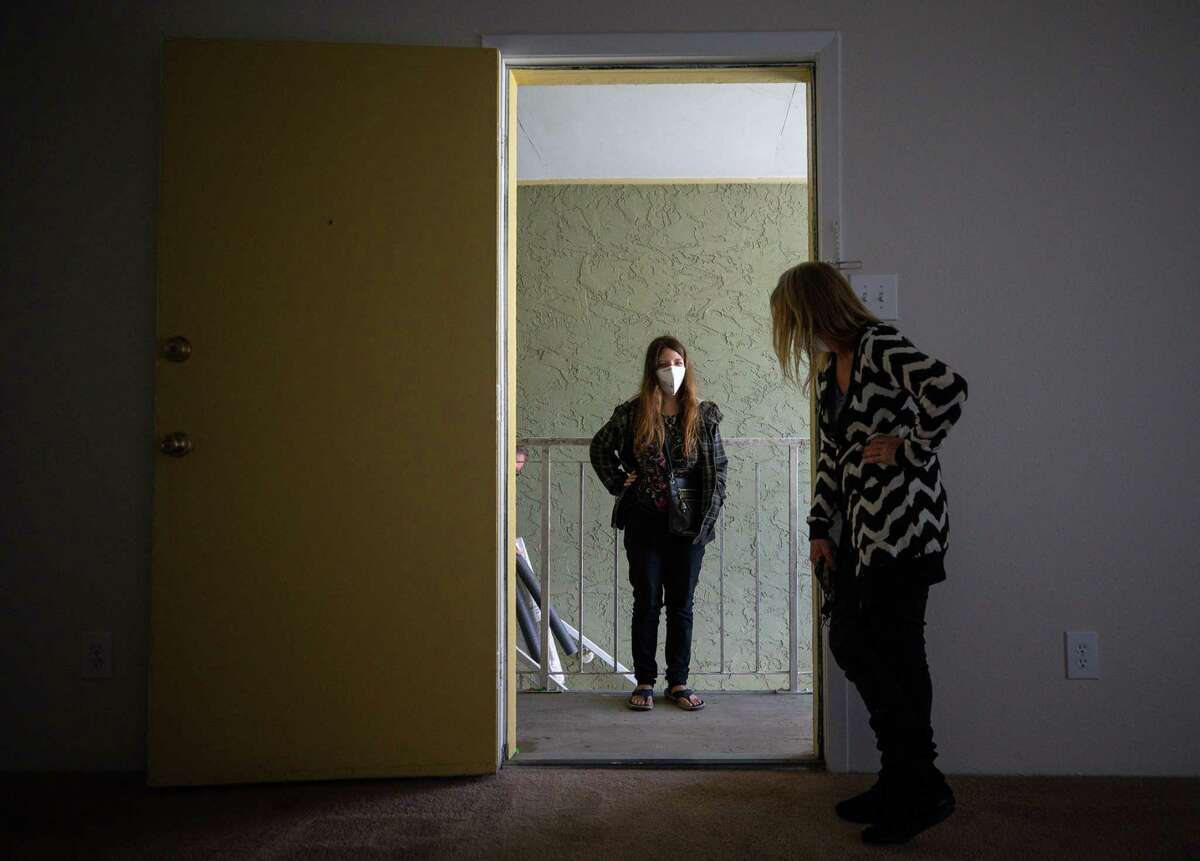 Aaliyah Lewis, center, and her mother Tina Harris, right, check out their new apartment at Carelton Courtyard Apartments on Tuesday, March 16, 2021, in Galveston, Texas. The two had been living at the Sandpiper Cove Apartments prior to this.