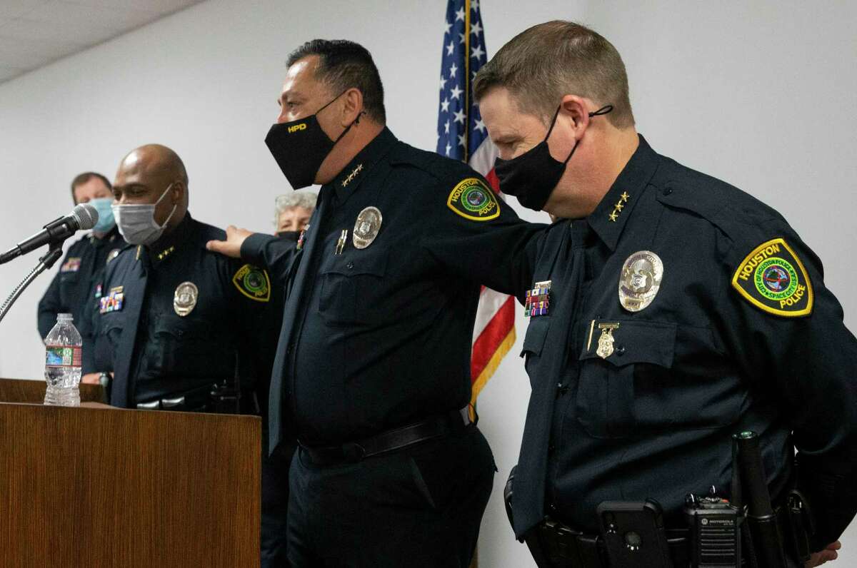 Houston Police Chief Art Acevedo puts his arms on Executive Assistant Chiefs Troy Finner, left, and Matt Slinkard while praising his his executive team and saying the city will be in good hands when he left the city during a press conference Tuesday, March 16, 2021, in Houston. Acevedo talked about leaving Houston for the same position at Miami Police Department.