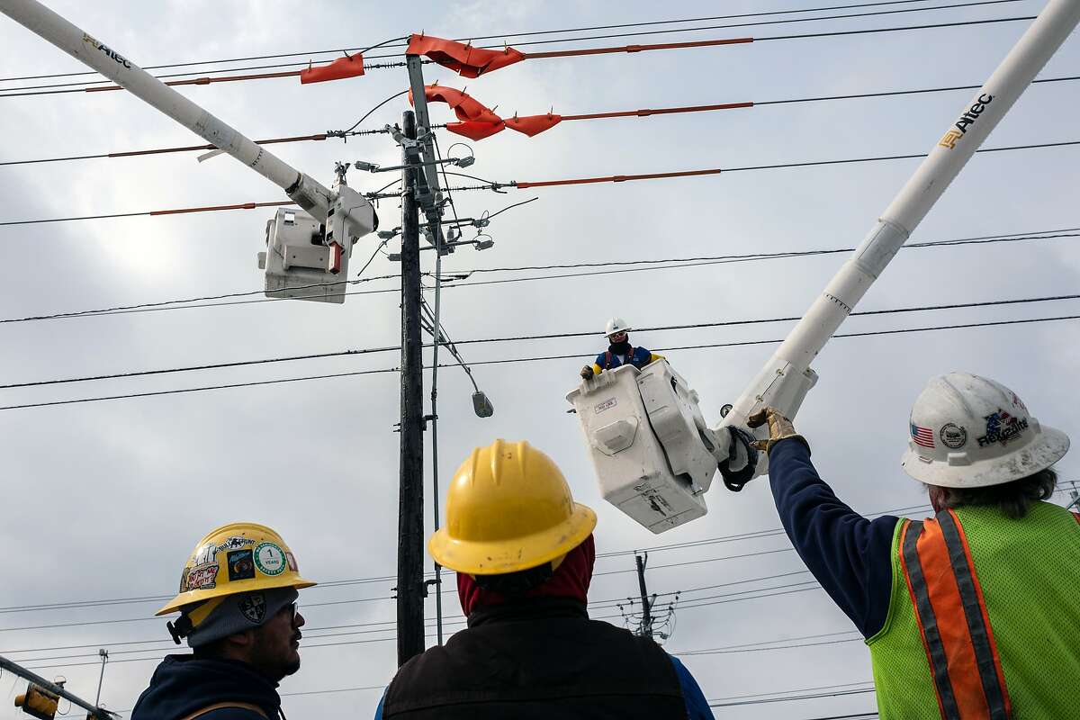 FILE -- Workers repair a utility pole after the winter storm in Austin, Texas, Feb. 18, 2021. The Electric Reliability Council of Texas decided to force out its chief executive on March 3 after the agency, which controls the flow of electricity through much of the state, became the target of blame and scorn for widespread outages during the February winter storm. (Tamir Kalifa/The New York Times)
