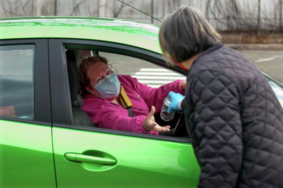 Gale Haskell, who drove up in a green Toyota, receives her lunch of corned beef and cabbage.