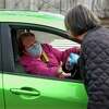 Gale Haskell, who drove up in a green Toyota, receives her lunch of corned beef and cabbage.