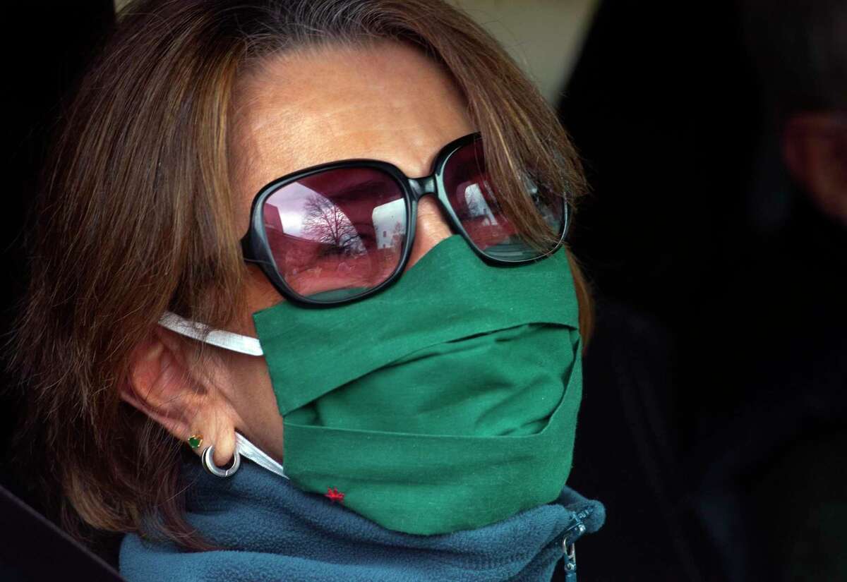 Carmen Davenport, sporting a holiday appropriate mask, as she waits for a free lunch of corned beef and cabbage, which were boxed up and handed out for a special St. Patrick's Day drive-thru luncheon at The Bigelow Center for Senior Activities in Fairfield, Conn., on Tuesday Mar. 16, 2021.