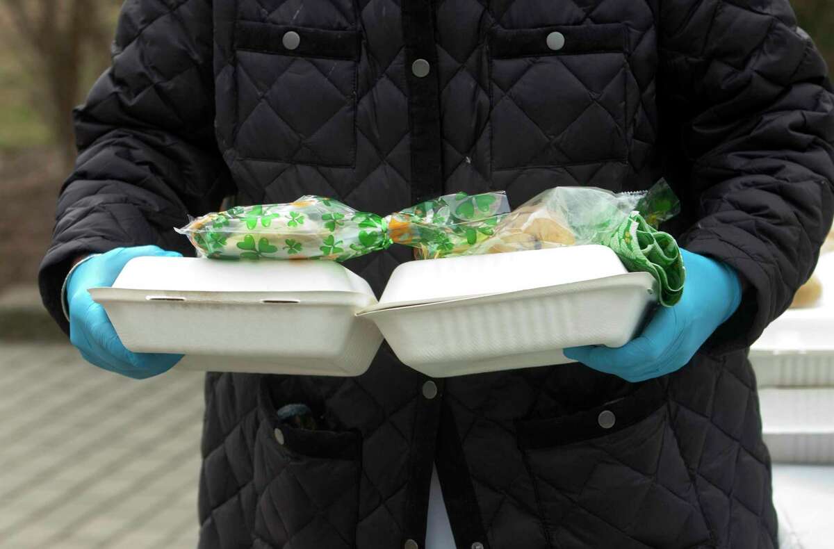 Lunches of corned beef and cabbage were boxed up and handed out for a special St. Patrick's Day drive-thru luncheon at The Bigelow Center for Senior Activities in Fairfield, Conn., on Tuesday Mar. 16, 2021.