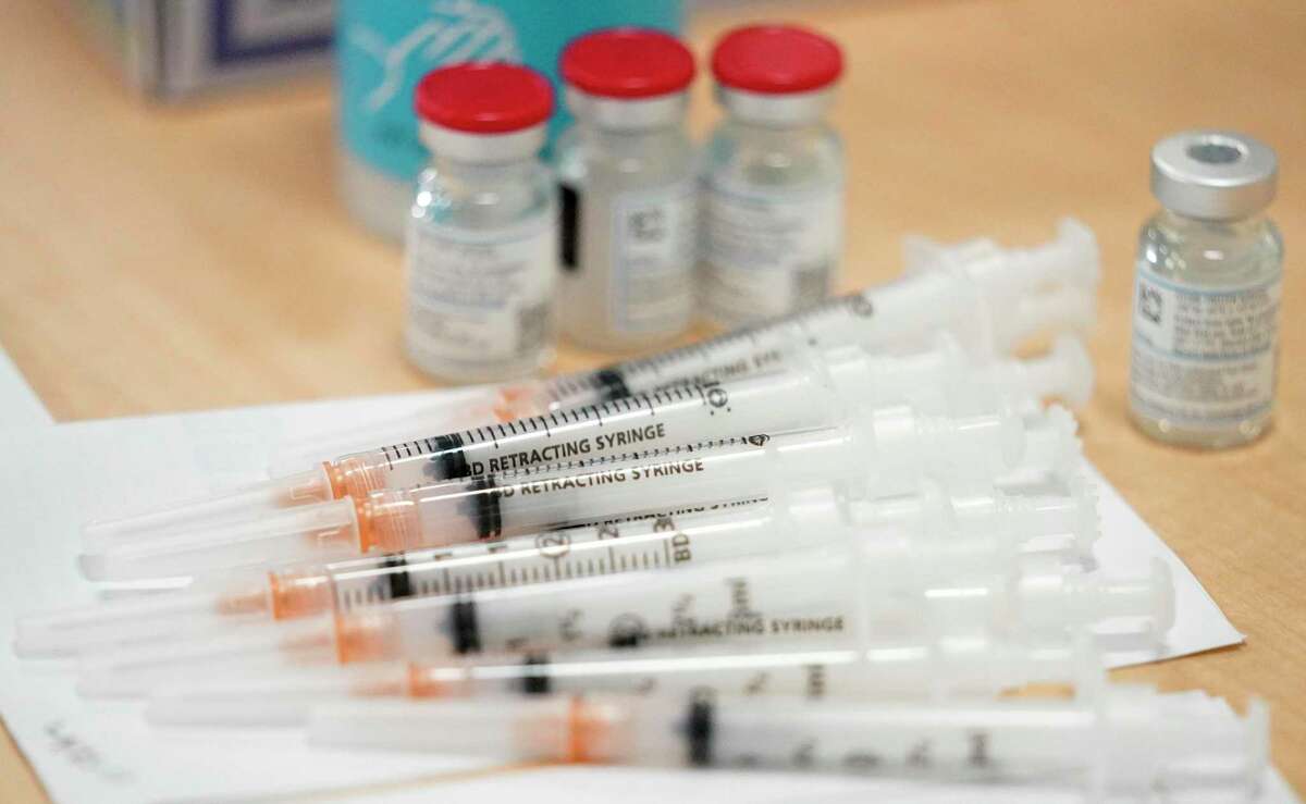 Syringes and vials of the Moderna COVID-19 vaccine are shown during an employee vaccination event.