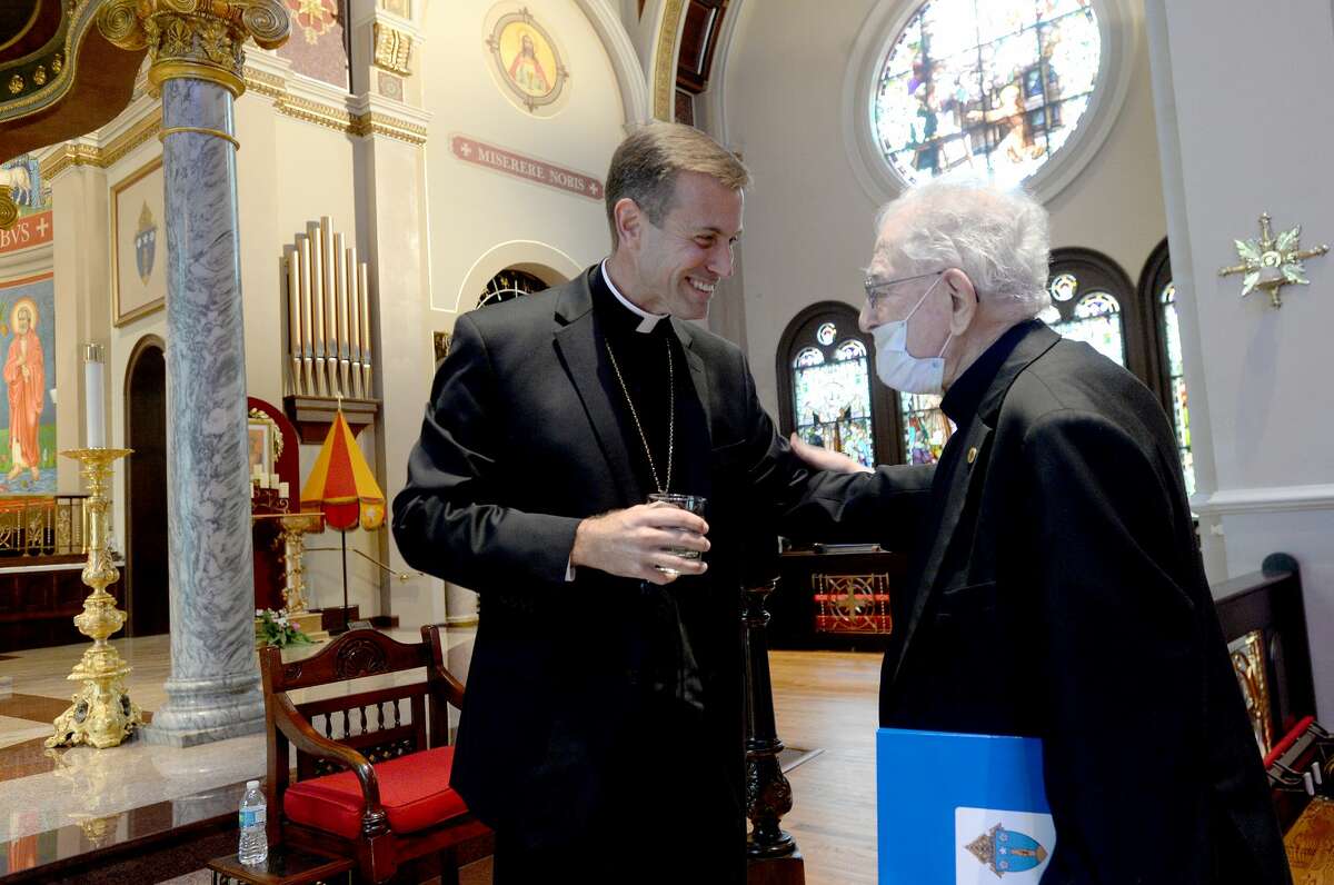 Msgr. David Toups, who was selected by Pope Francis to be the next Bishop of the Diocese of Beaumont upon the retirement of Bishop Curtis Guillory, jokes with Fr. Luis Urriza, who at 99 is the oldest priest in the diocese. Msgr. Toups, also a native of Louisiana, will be ordained as Bishop at St. Anthony Cathedral Basilica August 21. He will be the first leader of the diocese to be ordained a Bishop at the church. Photo taken Tuesday, June 9, 2020 Kim Brent/The Enterprise