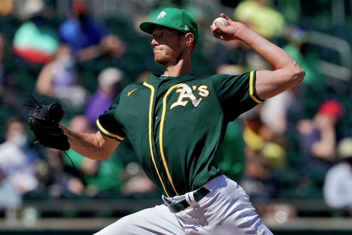 Oakland Athletics starting pitcher A.J. Puk throws against the Kansas City Royals during the first inning of a spring training baseball game, Wednesday, March 17, 2021, in Mesa, Ariz. (AP Photo/Matt York)