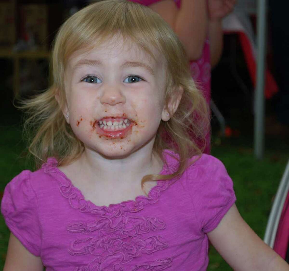 Kaley Herring, 2, of New Milford sports a chocolate smile after enjoying a chocolate chip cookie from Kelly's Sweet Spot at the Greater New Milford Chamber of Commerce's A Taste of New Milford held on the Village Green Sept. 8, 2010.