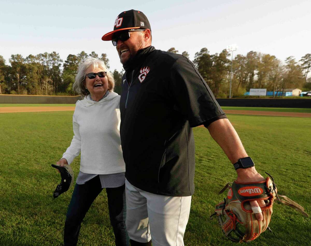 Annette Ferrell shares a moment with her son, Lou, after throwing out the first pitch before a District 13-6A high school baseball game at Conroe High School, Wednesday, March 17, 2021, in Conroe. The Conroe Tigers honored Annette’s huband and longtime coach Mike Ferrell before the game. Ferrell, who lead the Tigers for 33 years, died last August.