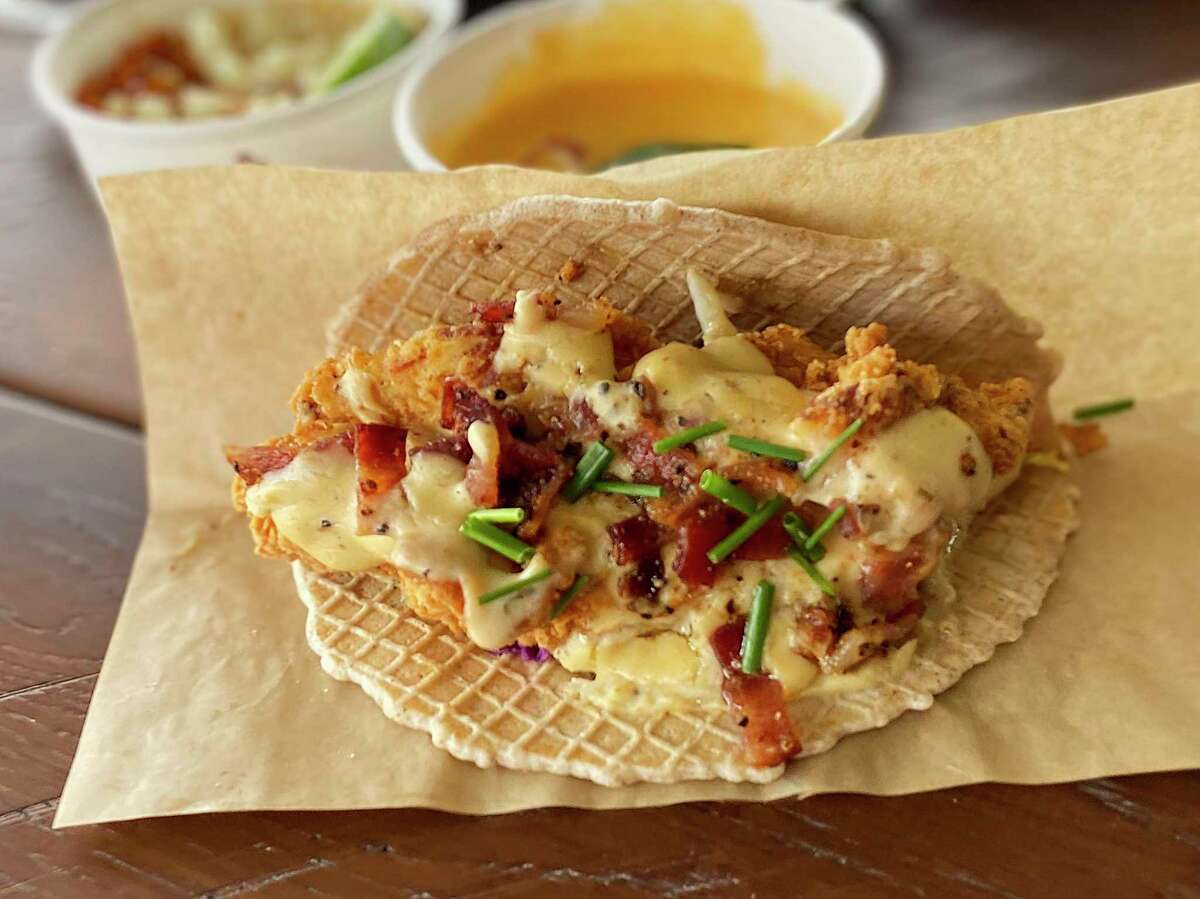 A chicken-and-waffle taco at the new Velvet Taco near The Rim incorporates fried chicken, gravy, green apple slaw and maple syrup on a waffle tortilla.