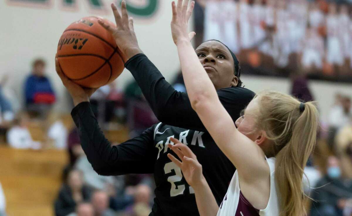 Kingwood Park forward Biva Byrd (21) shoots for the basket while being blocked by Magnolia forward Luci Salerno (12) during the fourth quarter of a Region III-5A girls basketball bi-district game at The Woodlands High School, Friday, Feb. 12, 2021, in The Woodlands.