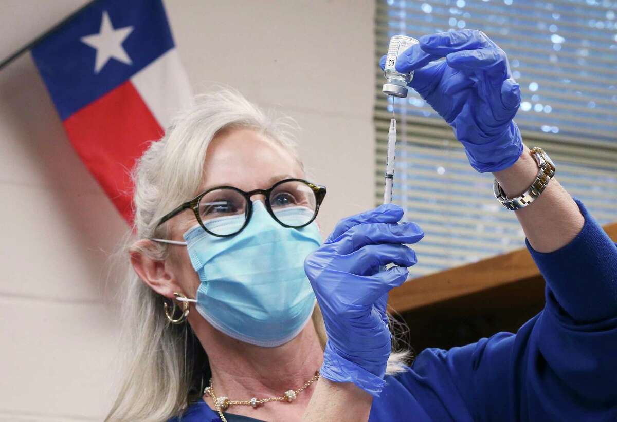 Southwest General Hospital's Christi Garfield loads a dose of the Moderna Covid-19 vaccine into a syringe in the library of Losoya Middle School as the hospital and Southside ISD partner together to administer 200 doses of the vaccine at Southside ISD campuses on Thursday, March 18, 2021.