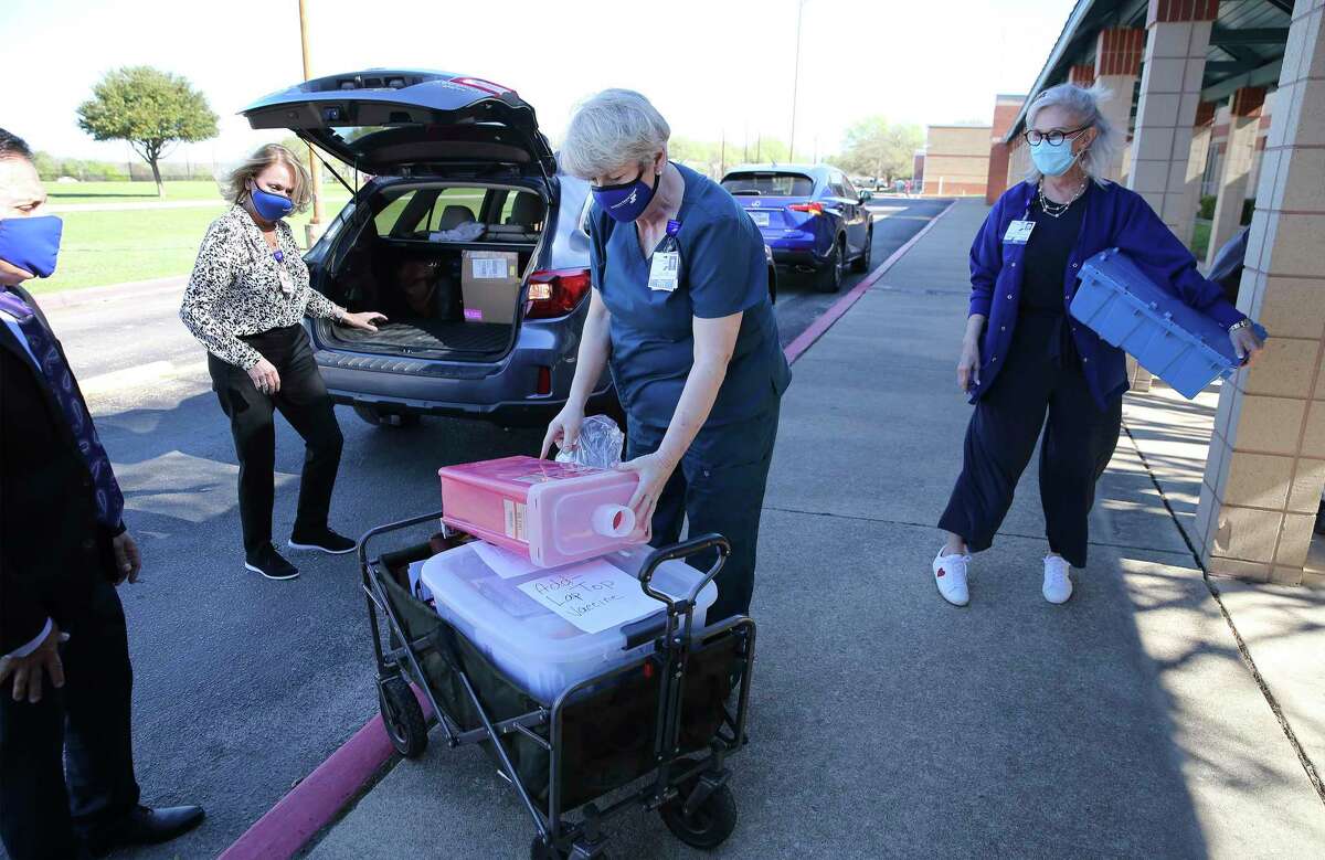Southwest General Hospital's Christi Garfield (from right), Judy Foster and Tammy Windsor, Covid vaccine coordinator, gather their supplies and meet with Southside ISD spokesperson Randy Escamilla (left) as the hospital and school district partner together to administer 200 doses of the Moderna Covid-19 vaccine at Southside campuses on Thursday, March 18, 2021.