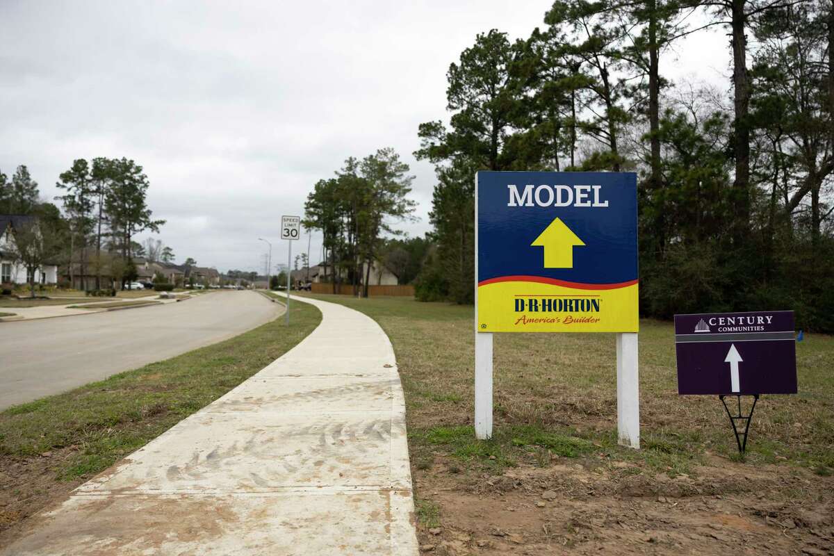 Signage points visitors to see new modeled homes in a new development called Raleigh Creek, Saturday, Jan. 30, 2021, in Tomball.