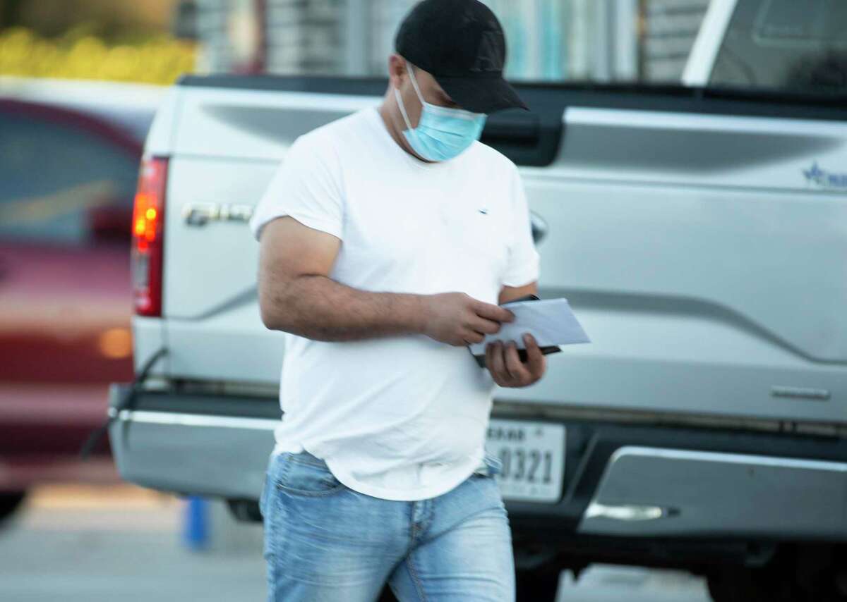 Rossel Mardiga walks out of a CVS Pharmacy after waiting two hours in hope to get a dose of leftover COVID-19 vaccine Thursday, March 18, 2021, at East End in Houston. Mardiga had an emergency trip come up and wouldn't be able to make his scheduled appointment, so he thought he'd try his luck.