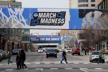 March Madness banners for the NCAA college basketball tournament cover crosswalks in downtown Indianapolis on Wednesday.