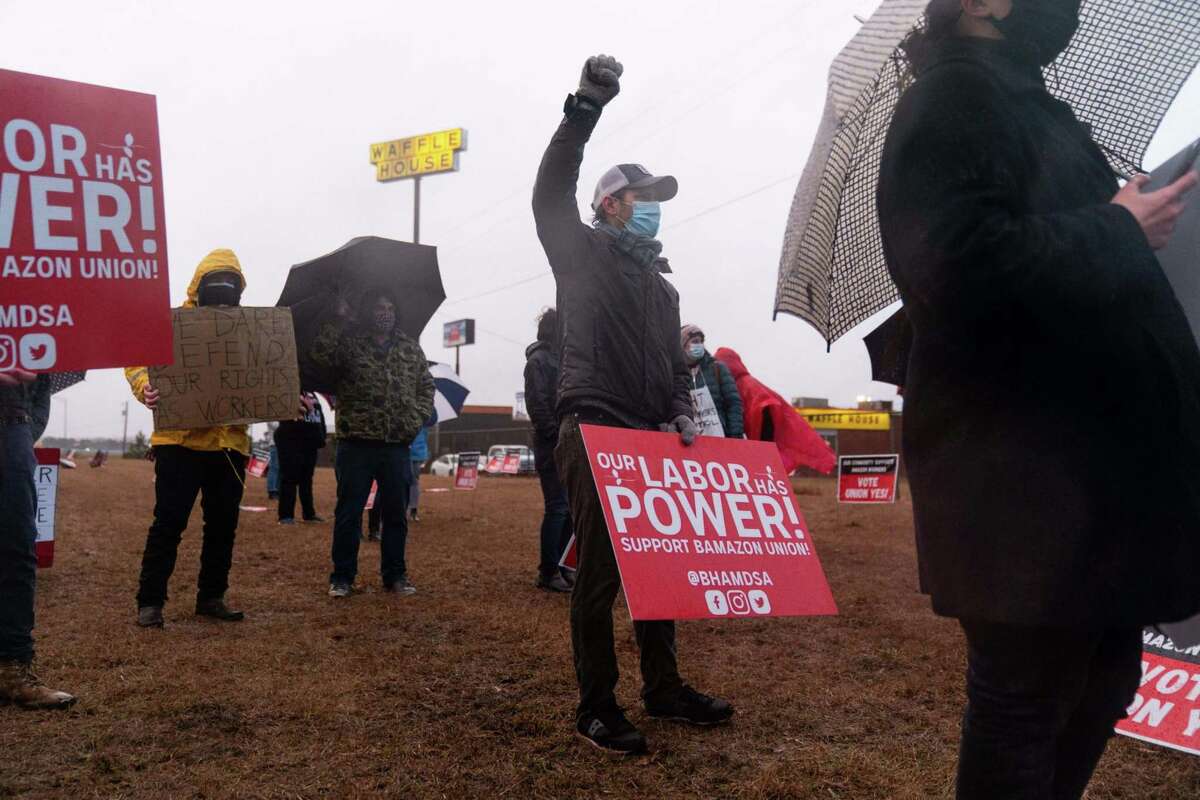 Demonstrators hold signs during a Retail, Wholesale and Department Store Union (RWDSU) held protest near the Amazon.com BHM1 Fulfillment Center in Bessemer, Ala., on Feb. 6, 2021.
