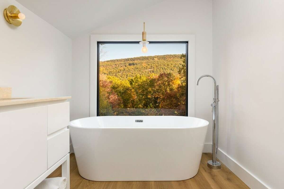 When Wallach was designing the High Falls house as an Airbnb rental, she envisioned the view from the bathroom being her main selling point. She installed a picture window and a soaking tub from which to enjoy the Mohonk Preserve views. “I was like, 'This is the money shot of the tub and the mountains…who wouldn't want to sit in this tub and look at this view?'”