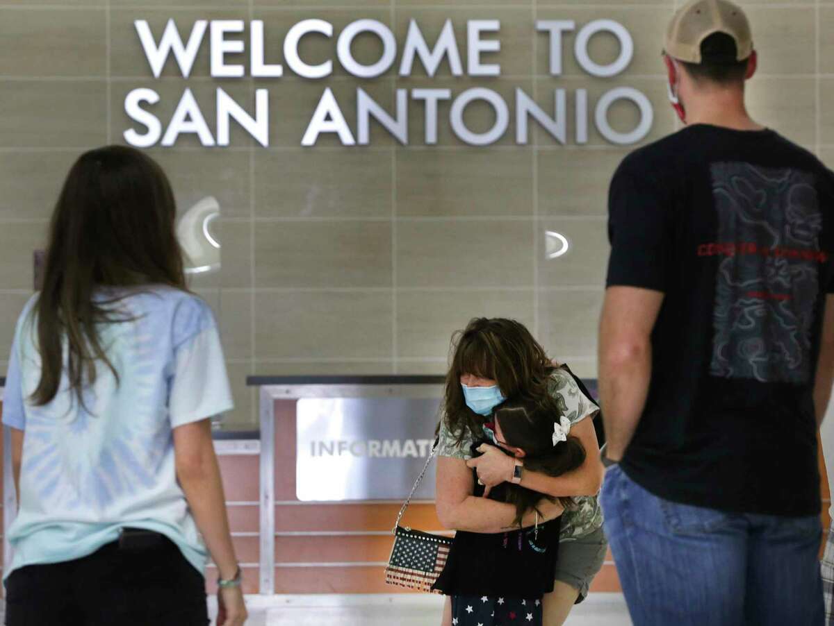 Cecilia Staples, center, of Arizona, hugs her granddaughter Ivee Baker, 6, as the Staples arrive at the San Antonio International Airport for the upcoming Thanksgiving celebrations, on Monday, Nov. 23, 2020. Ivee’s parents Kimberley Baker, left, and John Baker, right, wait for their hugs.