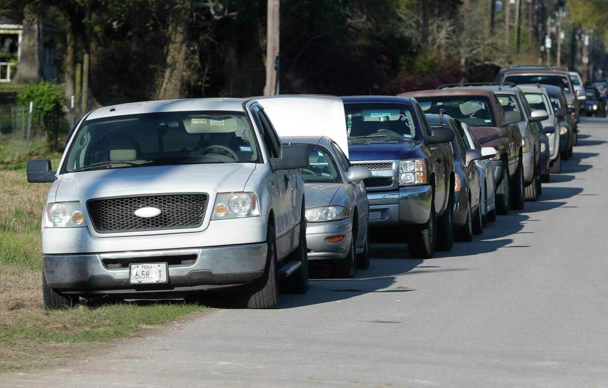 Cars line up for a mobile food distribution at the East Texas Dream Center, Friday, March 19, 2021, in Splendora. Volunteers handed out food for 200 families.
