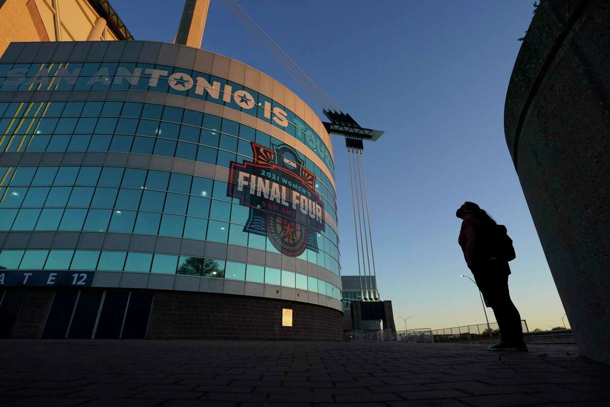 A visitor looks up at the logo for the Women’s Final Four at the Alamodome.