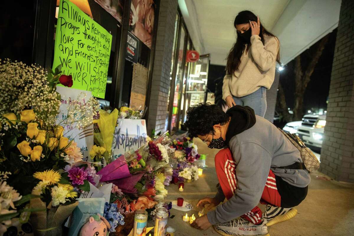 Mourners leave battery-powered candles outside Young's Asian Massage in Acworth, Ga., March 18, 2021, one of three massage businesses where eight people were killed and another injured by a shooter on Tuesday. The Atlanta police said on Thursday that the man charged with killing eight people, including six women of Asian descent, had been a customer at two spas that were attacked. (Jeenah Moon/The New York Times)