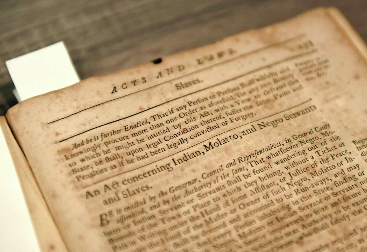 Historical documents mentioning slavery are displayed in the archives at the Greenwich Historical Society.