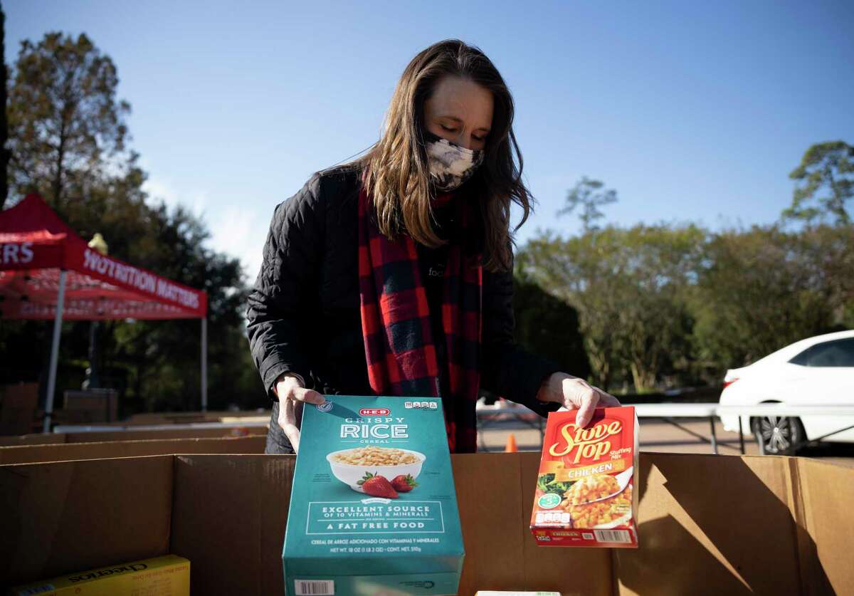 Montgomery County Food Bank president, Kristine Marlow, looks through a box of donated food during a holiday food drive held at the Woodlands United Methodist Church, Friday, Dec. 4, 2020. Donations were accepted throughout the day at The Woodlands location and in Conroe. Marlow was the featured speaker at the Lake Conroe Centennial Lions Club’s recent meeting.