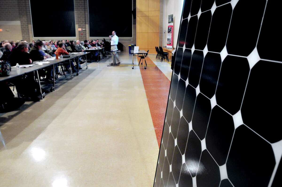 Madison residents pack the cafeteria of Daniel Hand High School in Madison for a presentation about solar energy by Chris Lenda, president and CEO of Aegis Solar Energy, on 4/3/2013. Photo by Arnold Gold/New Haven Register AG0490C