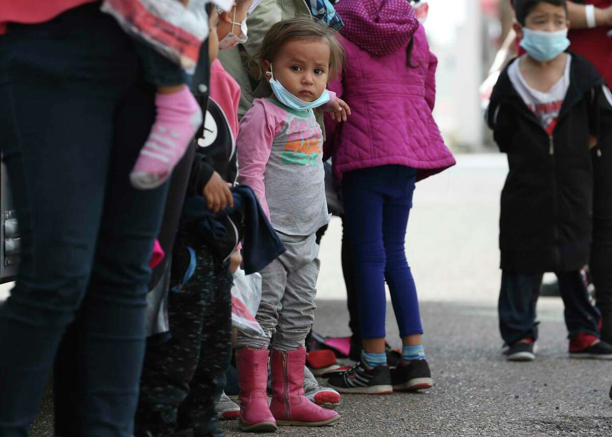 Migrant families arrive at a COVID-19 testing center in McAllen.