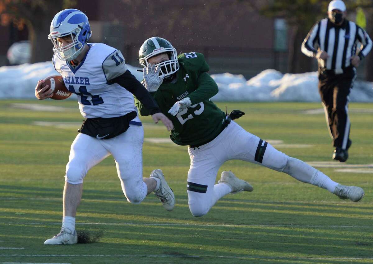 Shen linebacker Nick Bagramian attempts to tackle Shaker quarterback Joey Mirabile as he runs the ball during a game Friday, Mar. 19, 2021, in Clifton Park, N.Y. (Jenn March, Special to the Times Union )