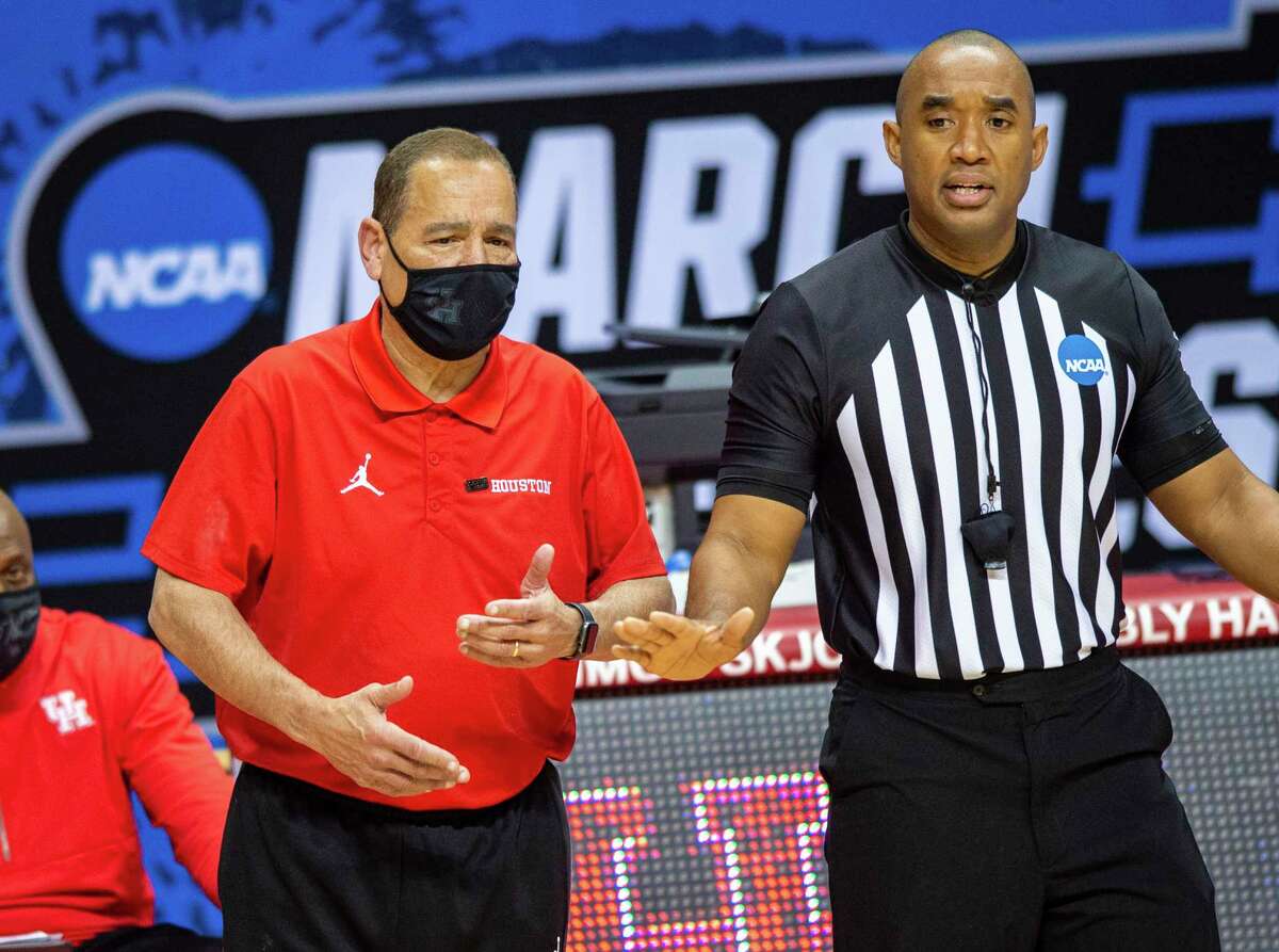 Houston head coach Kelvin Sampson talks with a game official during the second half of a first-round game against Cleveland State in the NCAA men's college basketball tournament, Friday, March 19, 2021, at Assembly Hall in Bloomington, Ind. (AP Photo/Doug McSchooler)