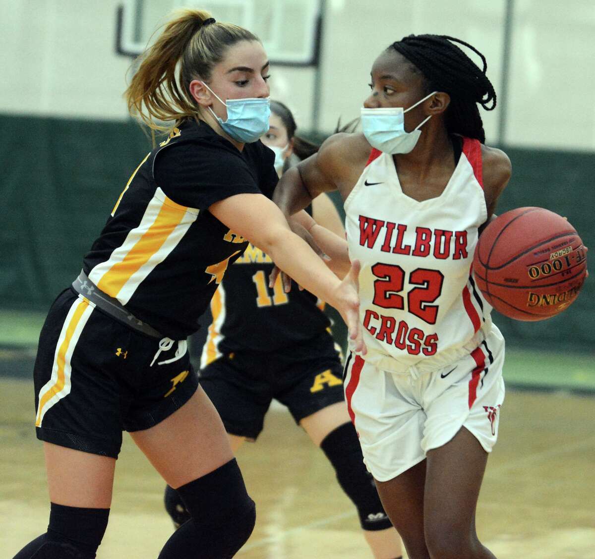 Wilbur Cross’ Dejah Middleton (22) tries to get past Amity Regional’s Ribekah Marchitto (44) during an SCC girls basketball playoff game on Friday, March 19, 2021 at the Floyd Little Athletic Center in New Haven, Conn.