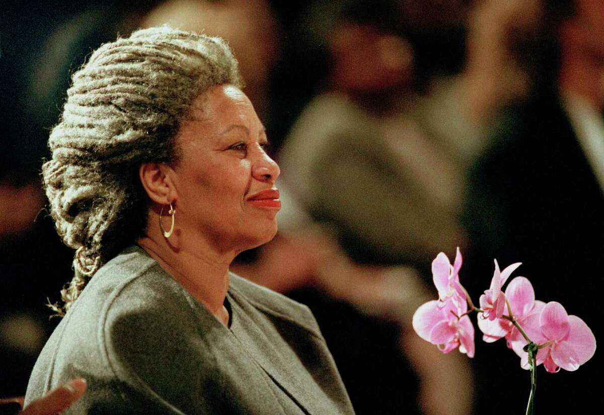 FILE - In this April 5, 1994, file photo, Toni Morrison as she holds an orchid at the Cathedral of St. John the Divine in New York. Publisher Alfred A. Knopf says Morrison died Aug. 5, 2019, at Montefiore Medical Center in New York. She was 88. (AP Photo/Kathy Willens, File)