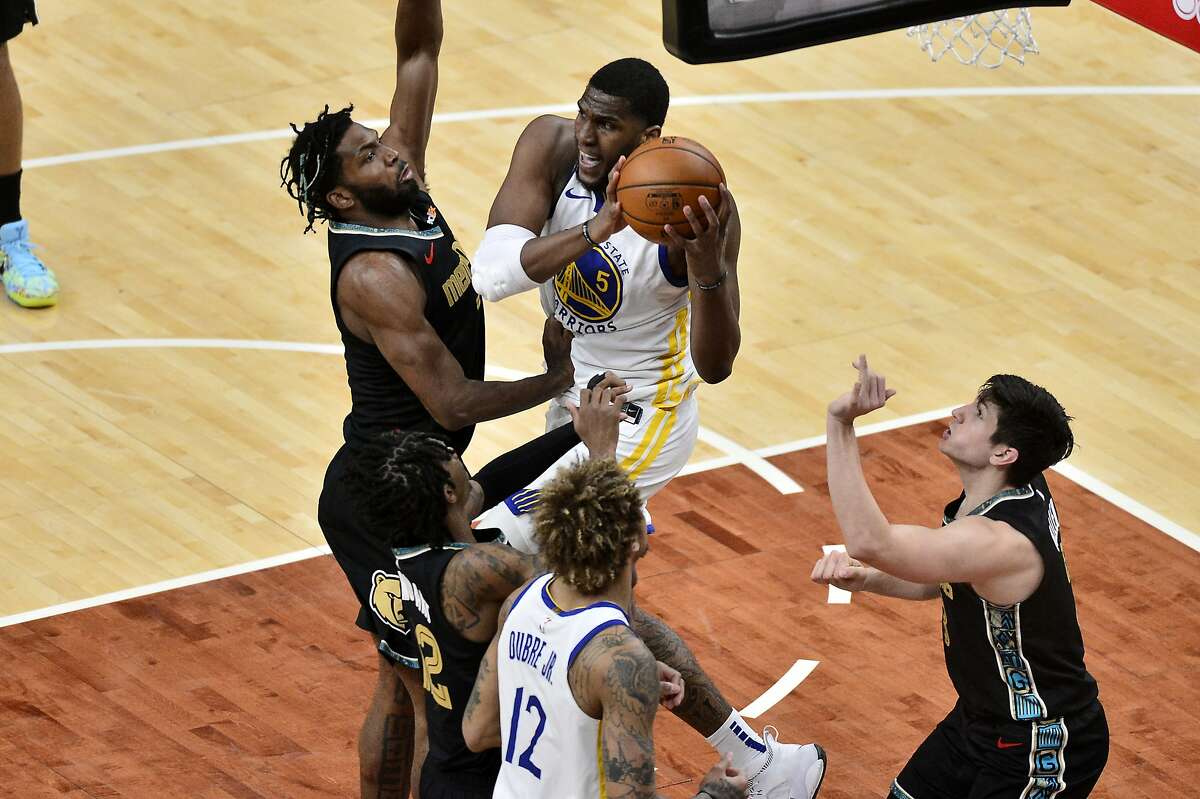 Golden State Warriors center Kevon Looney (5) handles the ball next to Memphis Grizzlies forward Justise Winslow, left, during the second half of an NBA basketball game Friday, March 19, 2021, in Memphis, Tenn. (AP Photo/Brandon Dill)