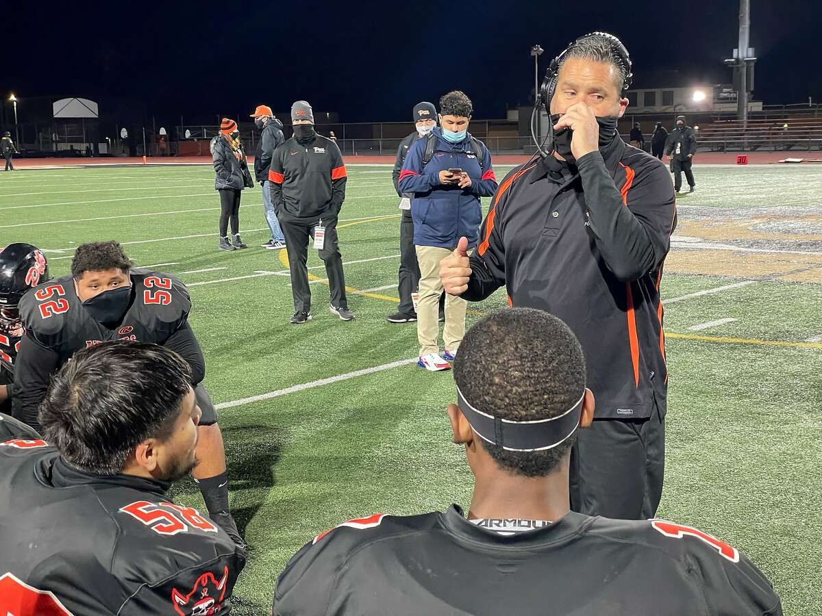 Pittsburg coach Victor Galli addresses his team after the Pirates’ victory over Freedom-Oakley on Friday night.