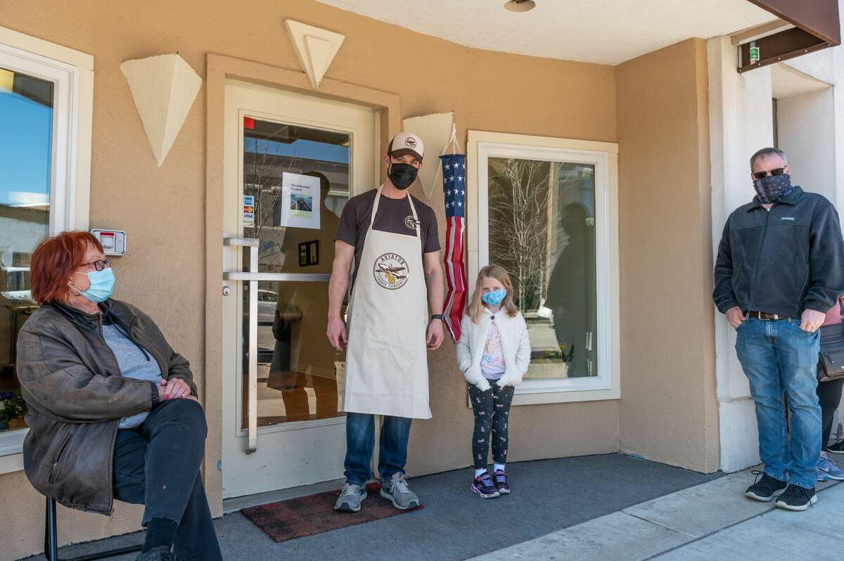 Maya Want poses with Aviator Cookie Company owner Chris Welch. Maya was the first customer in line at the grand opening of Aviator Cookie Company located at 230 E. Main St in Downtown Midland on March, 20, 2021 (Adam Ferman/for the Daily News)