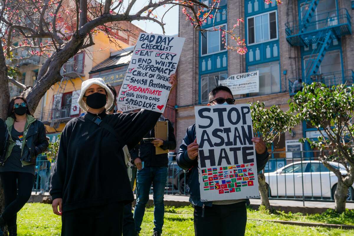 Participants at the Portsmouth Square event hold signs protesting against anti-Asian violence.