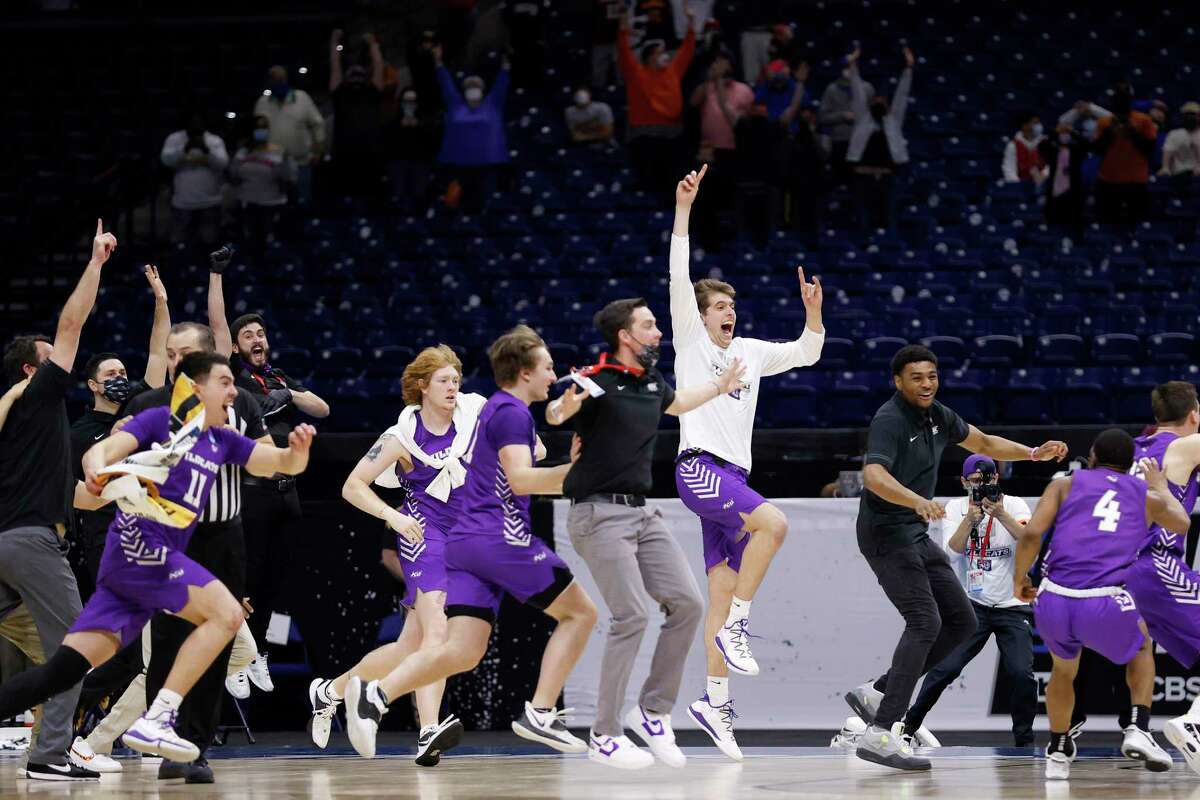 INDIANAPOLIS, INDIANA - MARCH 20: Abilene Christian Wildcats celebrate after defeating Texas Longhorns 53-52 in the first round game of the 2021 NCAA Men's Basketball Tournament at Lucas Oil Stadium on March 20, 2021 in Indianapolis, Indiana. (Photo by Jamie Squire/Getty Images)