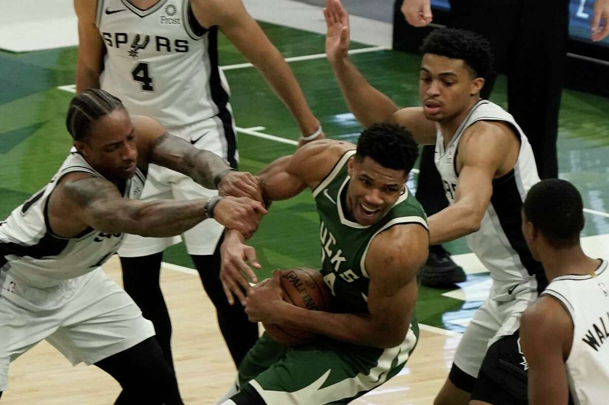 Milwaukee Bucks’ Giannis Antetokounmpo is fouled during the second half of an NBA game against the San Antonio Spurs on Saturday, March 20, 2021, in Milwaukee.