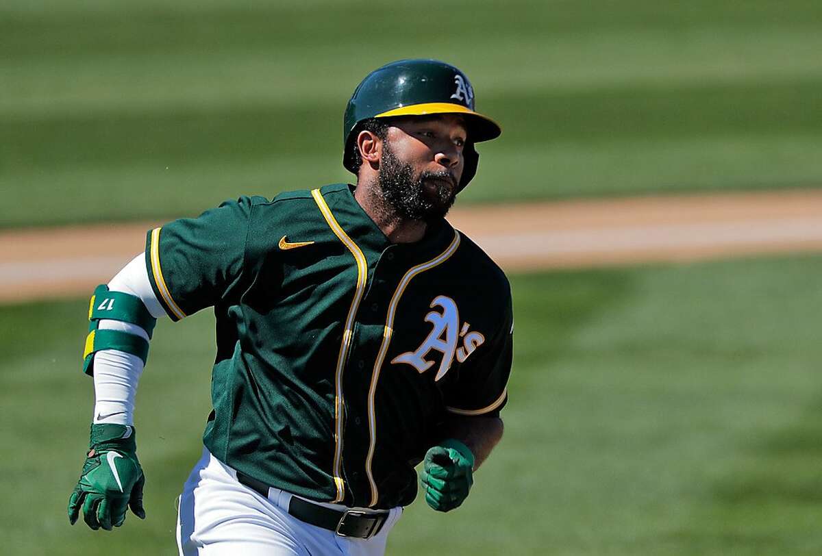 Elvis Andrus (17) rounds the bases on his double in the first inning as the Oakland Athletics played the Los Angeles Angels at Hohokam Stadium in Mesa, Ariz., on Friday, March 5, 2021.