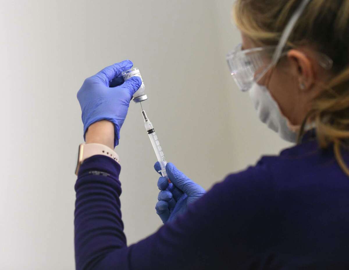 A nurse prepares the Moderna COVID-19 vaccine during the grand opening of the COVID-19 vaccine "super site" at Silicon Harbor in Stamford, Conn. Monday, March 15, 2021.