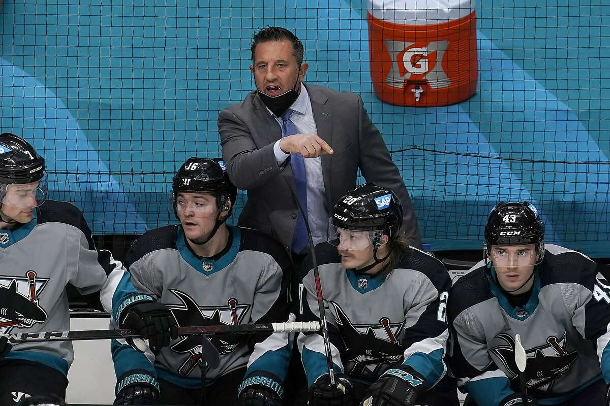 San Jose Sharks coach Bob Boughner, top, gestures to an official during the third period of the team's NHL hockey game against the St. Louis Blues in San Jose, Calif., Saturday, March 20, 2021. (AP Photo/Jeff Chiu)