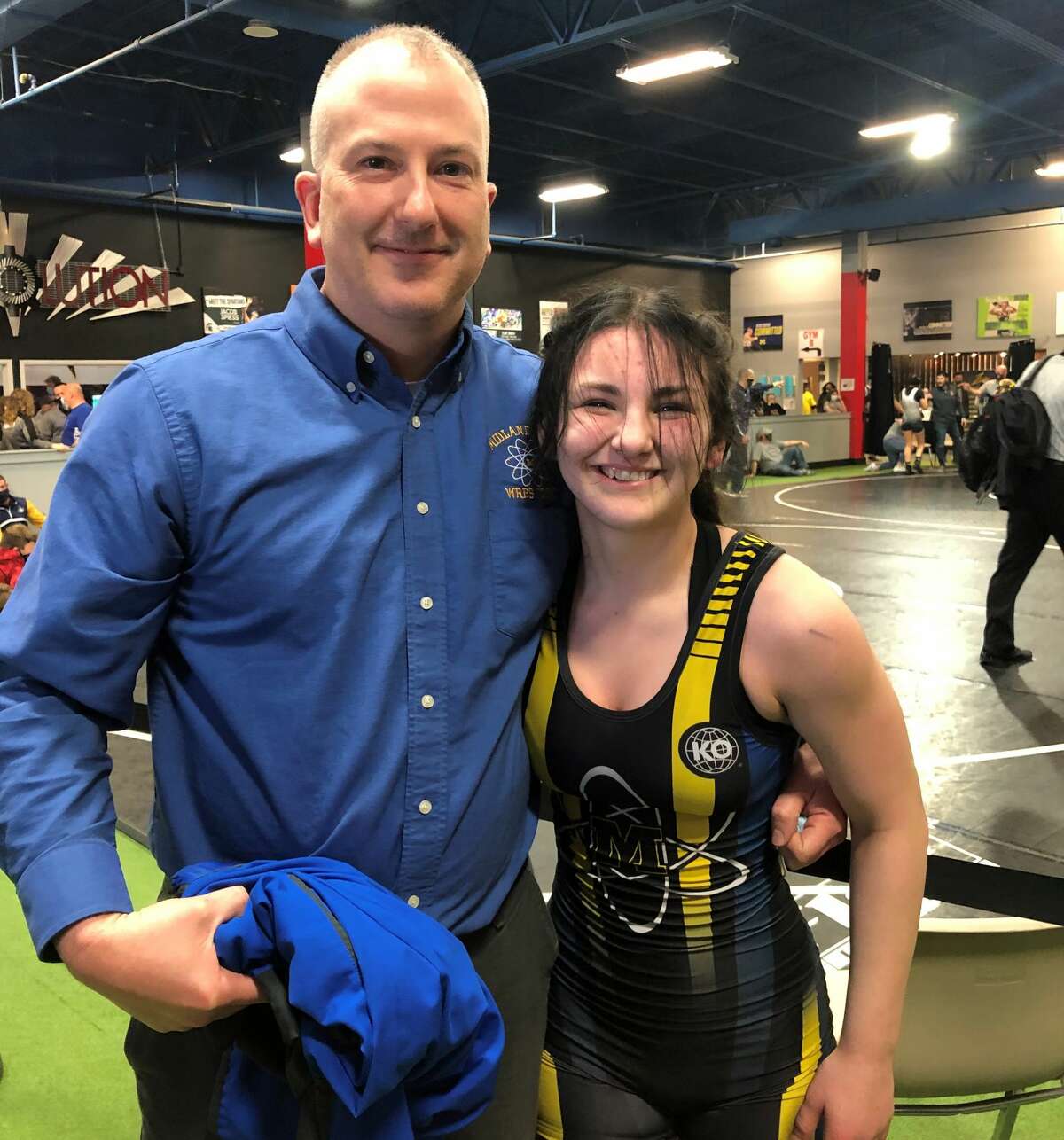 Midland High's Arden Eschtruth is all smiles after finishing third at the Michigan Wrestling Association girls' state finals on Sunday in Highland Park.