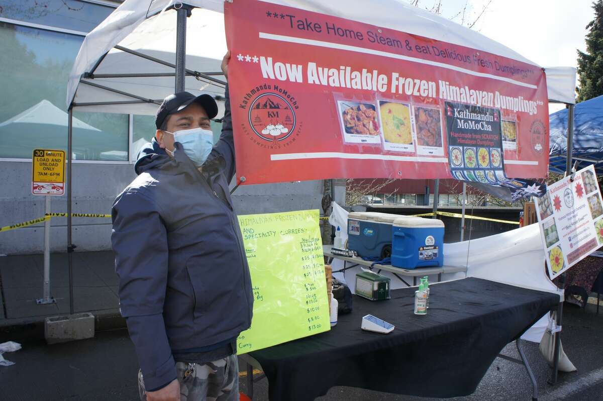 Sam Dangol at Kathmandu Momocha specializes in selling handmade dumplings. Now sold in frozen pre-packed packages, after 'no prepared food' rules on market premises were enforced for safety reasons.