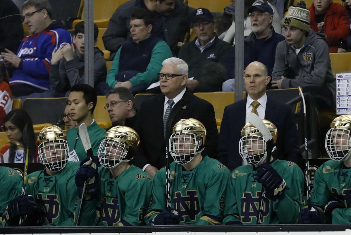 Jeff Jackson (behind bench) and his Notre Dame team will not be playing in the NCAA hockey reegional this weekend. (Photo by Fred Kfoury III/Icon Sportswire via Getty Images)